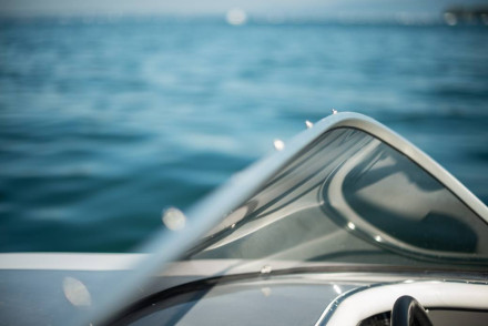Close-up of motorboat windshield and helm on open water representing recreational boating accident claims