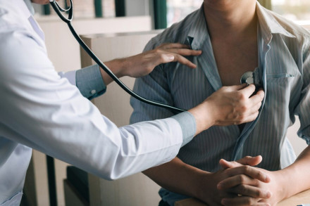 Doctor using stethoscope to examine patient chest during medical negligence evaluation